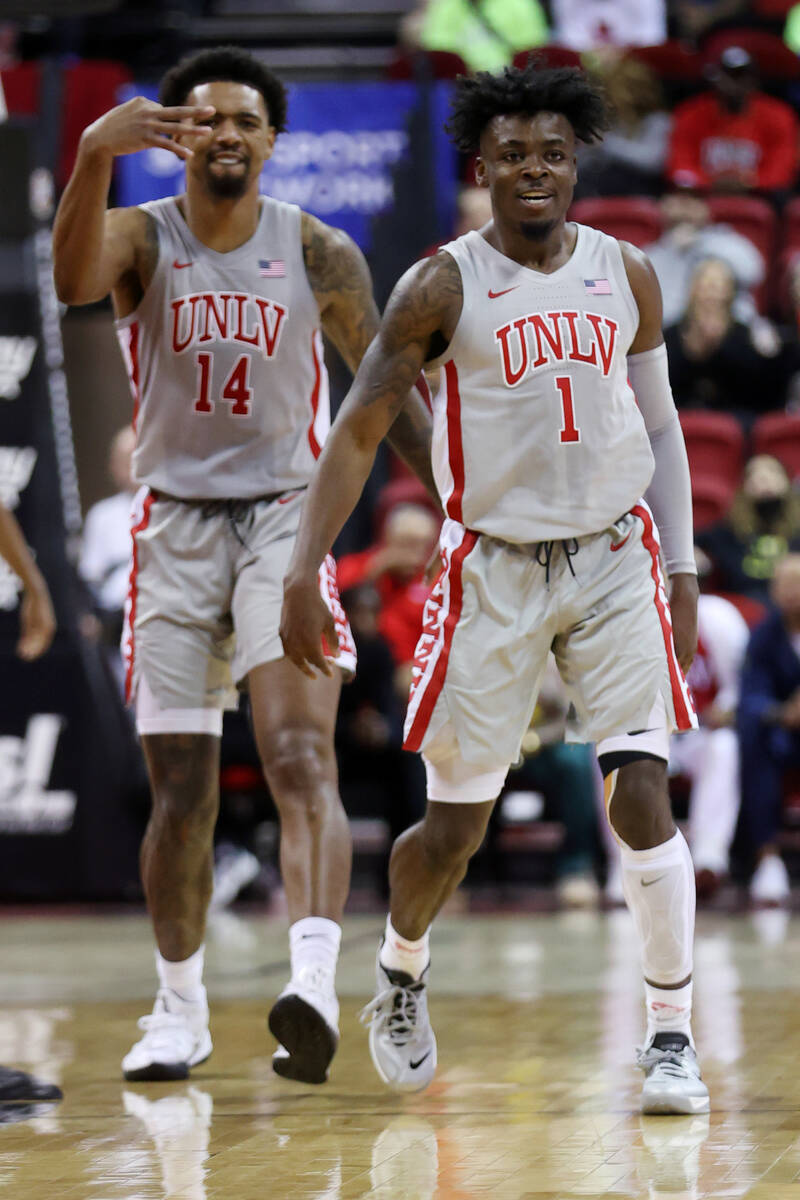 UNLV’s Jordan McCabe (1), with teammate Royce Hamm Jr. (14), reacts after shooting 3-poi ...