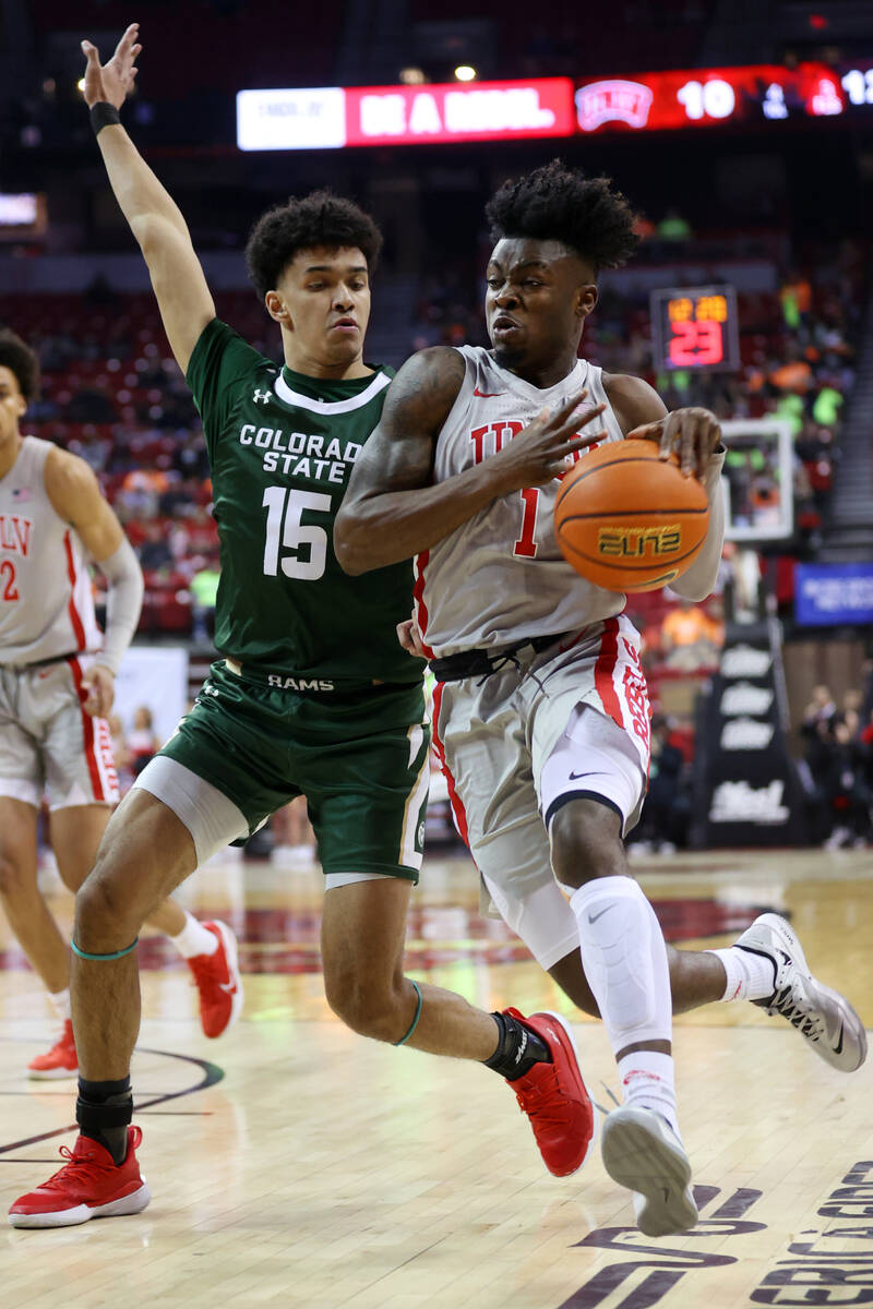 UNLV’s Michael Nuga (1) dribbles the ball to the hoop against Colorado State’s Ja ...