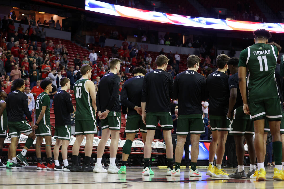 Colorado State players stand for the singing of the National Anthem before the start of a men&# ...