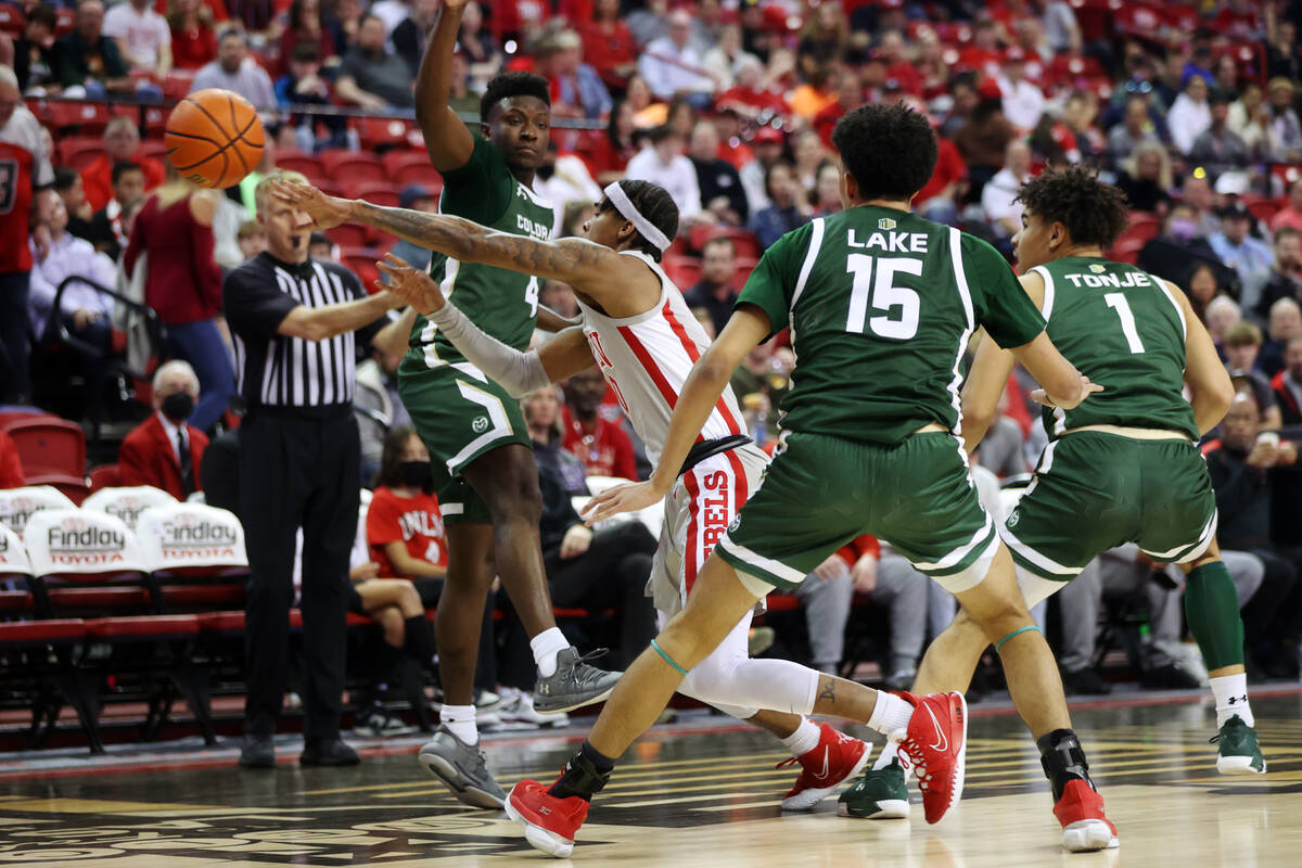 UNLV’s Keshon Gilbert (10) makes a pass under pressure by Colorado State’s Isaiah ...