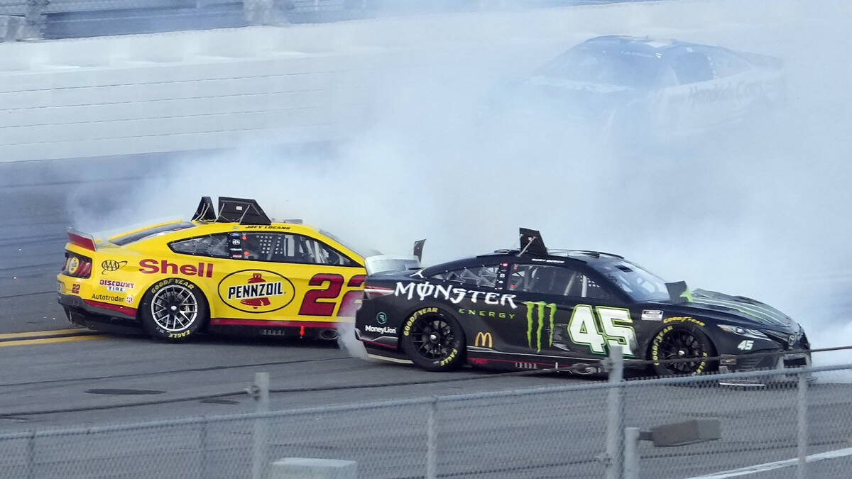 Kurt Busch (45) and Joey Logano (22) spin during the NASCAR Daytona 500 auto race Sunday, Feb. ...