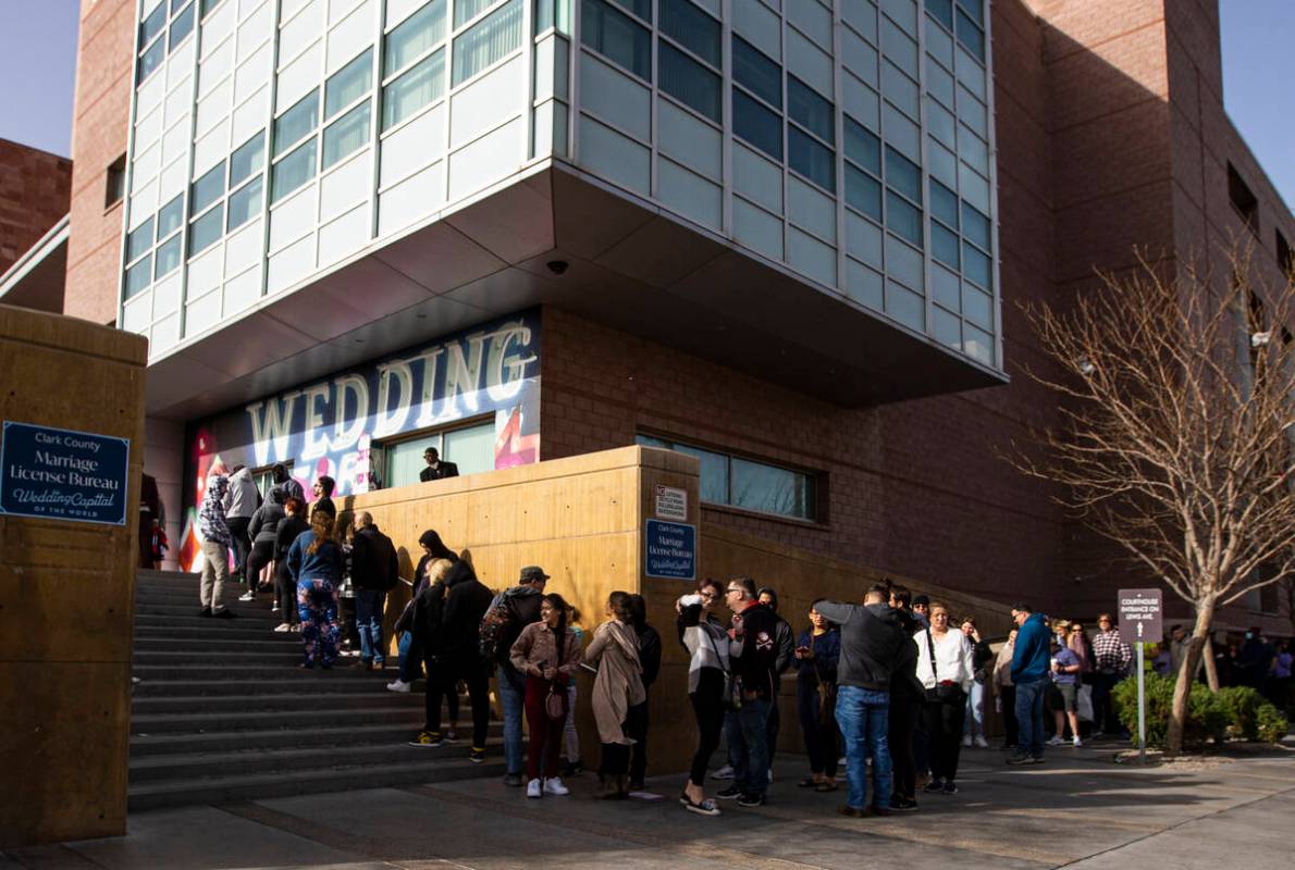 People wait in line at the Clark County Marriage License Bureau on Monday, Feb. 21, 2022, in La ...