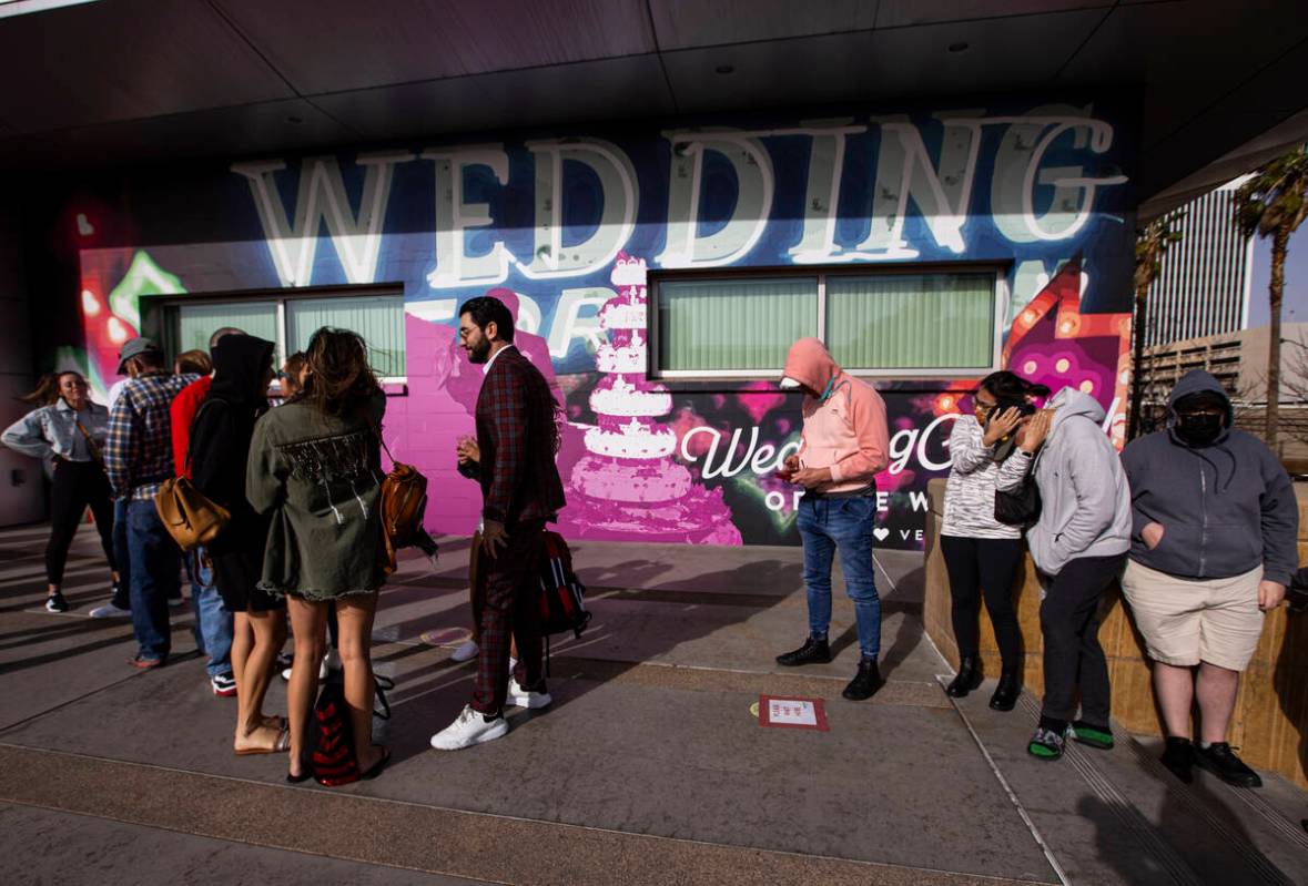 People wait in line at the Clark County Marriage License Bureau on Monday, Feb. 21, 2022, in La ...