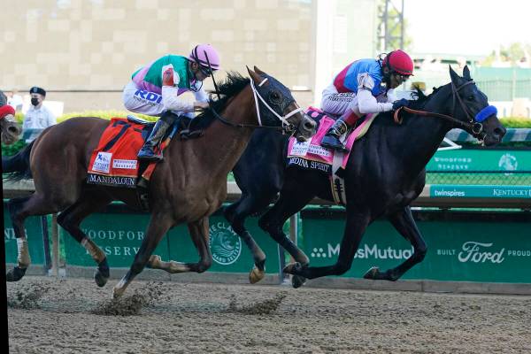 In this May 1, 2021, file photo, Medina Spirit, ridden by John Velazquez, right, leads Mandalou ...