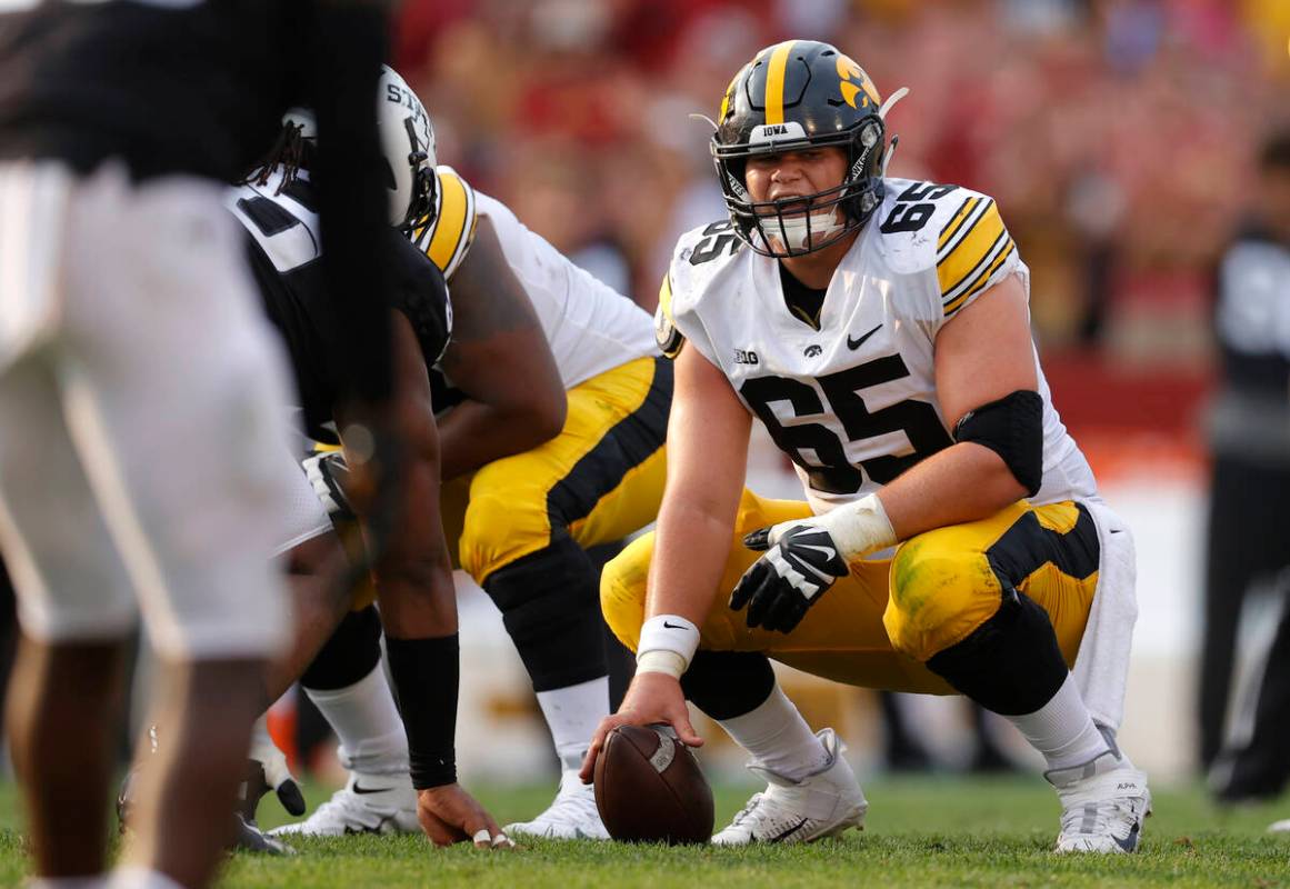 Iowa offensive lineman Tyler Linderbaum (65) gets set for a play during the second half of an N ...