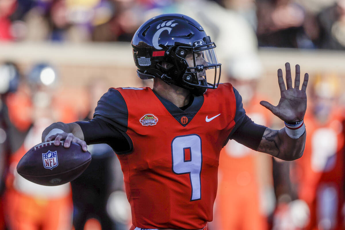 National Team quarterback Desmond Ridder of Cincinnati (9) throws a pass in an NCAA college foo ...