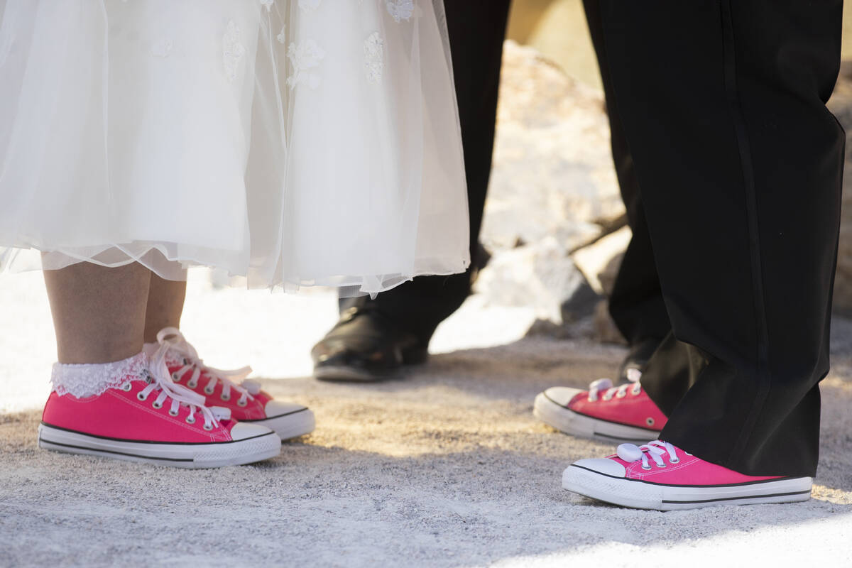 Javier Ansoleaga and Stephanie Hippensteel stand in front each other during their wedding cerem ...