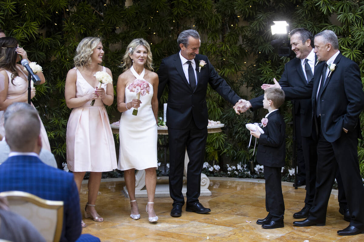 Sheila Daley, third from left, and her husband James Dunbar, hold hands following their wedding ...