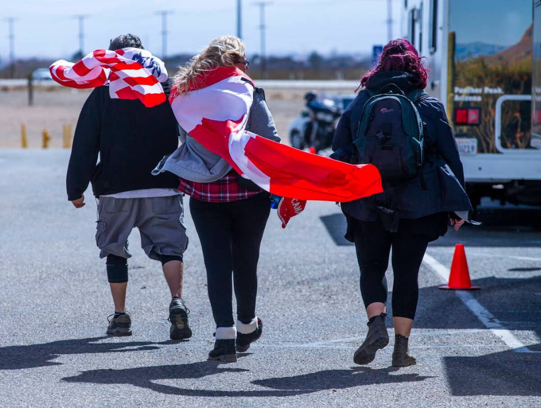 Attendees endure cold and high winds as they arrive early for The People’s Convoy stagin ...