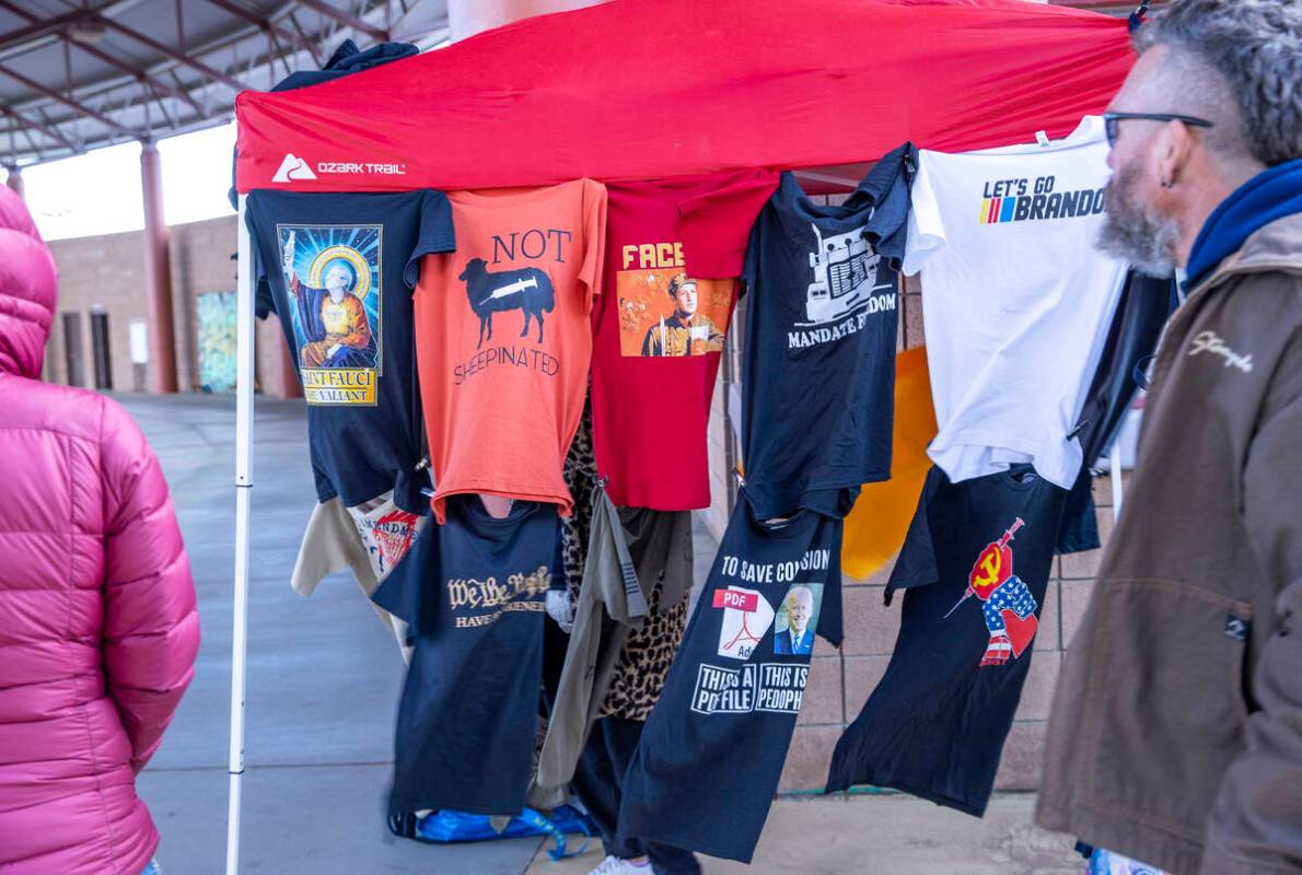 A t-shirt vendor sets up a stall as attendees begin to arrive for The People’s Convoy st ...