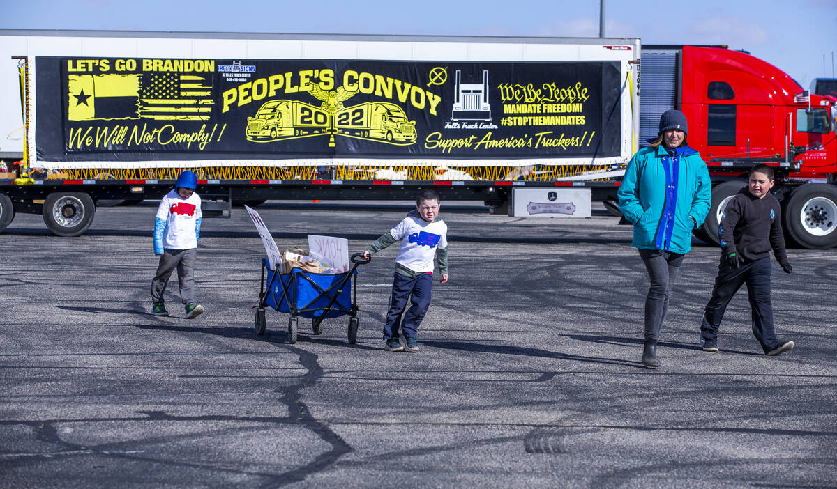 Attendees endure cold and high winds to pass out food donations to truck drivers for The People ...