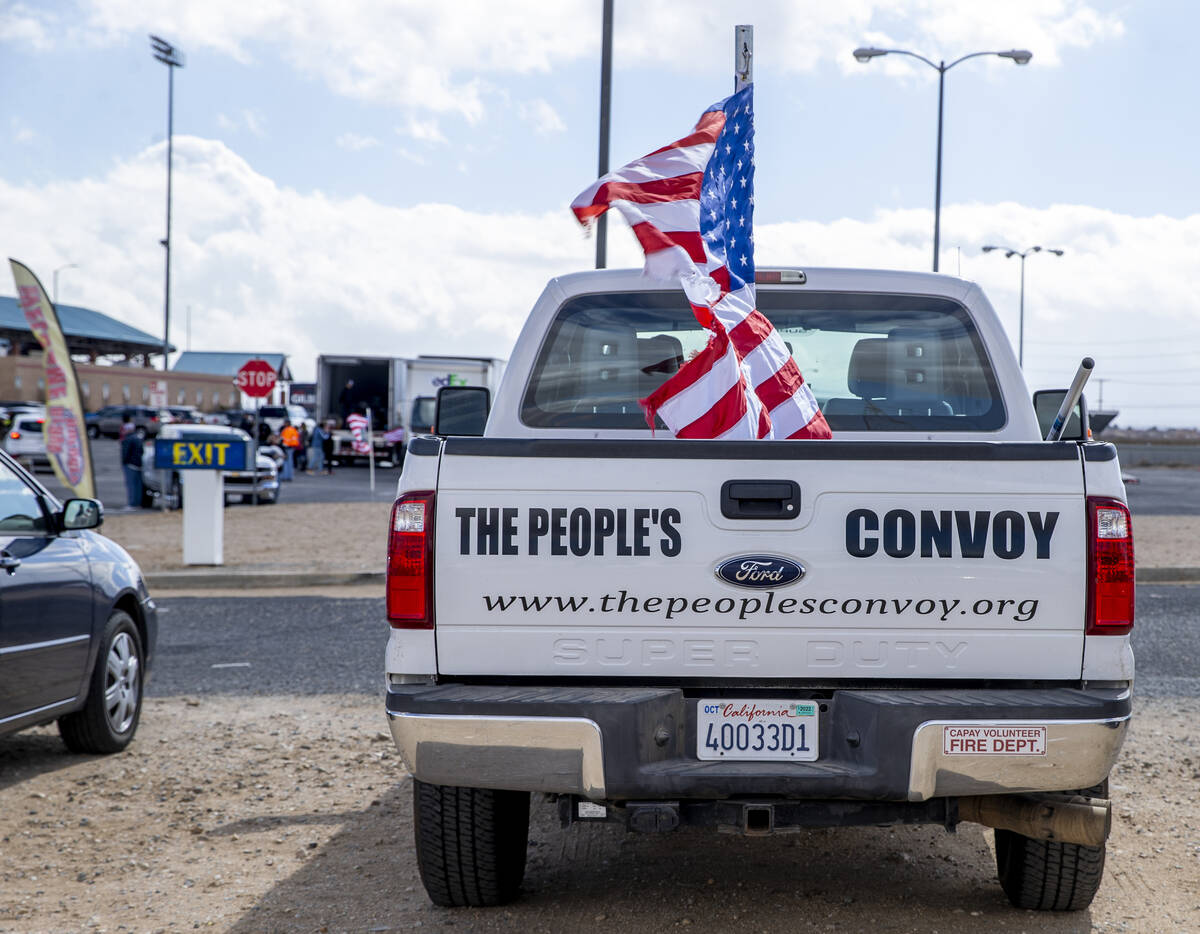 A truck in the parking lot advertises The People’s Convoy as attendees begin to arrive f ...