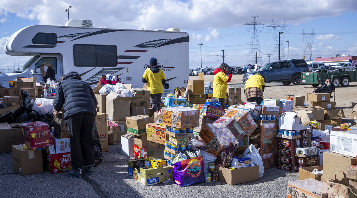 Food donations are sorted in the parking lot for The People’s Convoy as attendees begin ...