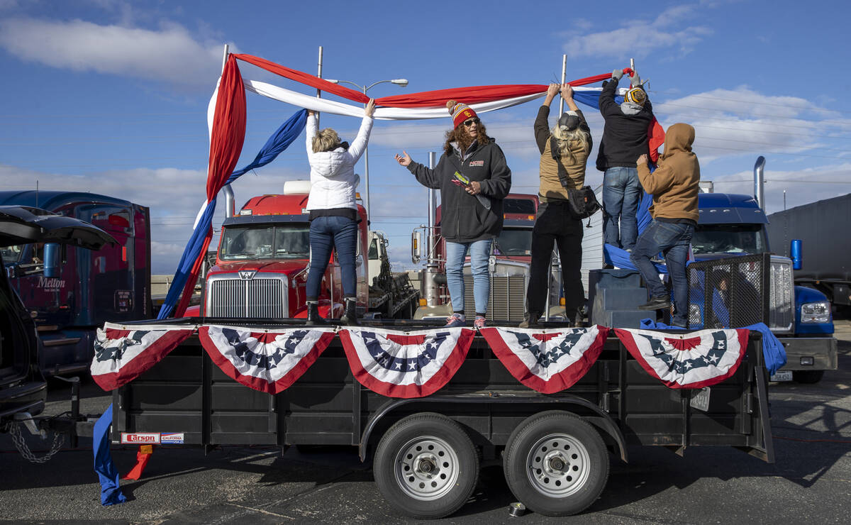 Organizers set up a stage for speakers for The People’s Convoy send off event at Adelant ...