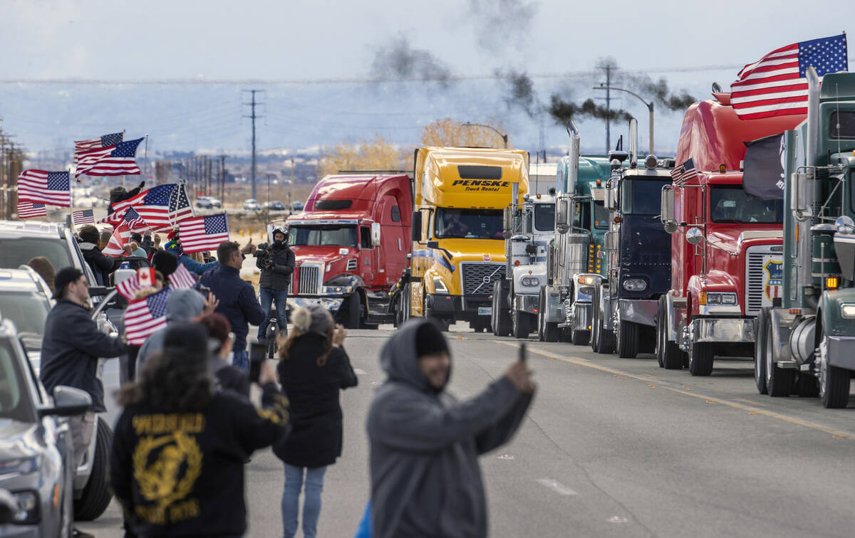 Supporters wave flags and cheer for truckers departing from a send-off event for The People’s ...