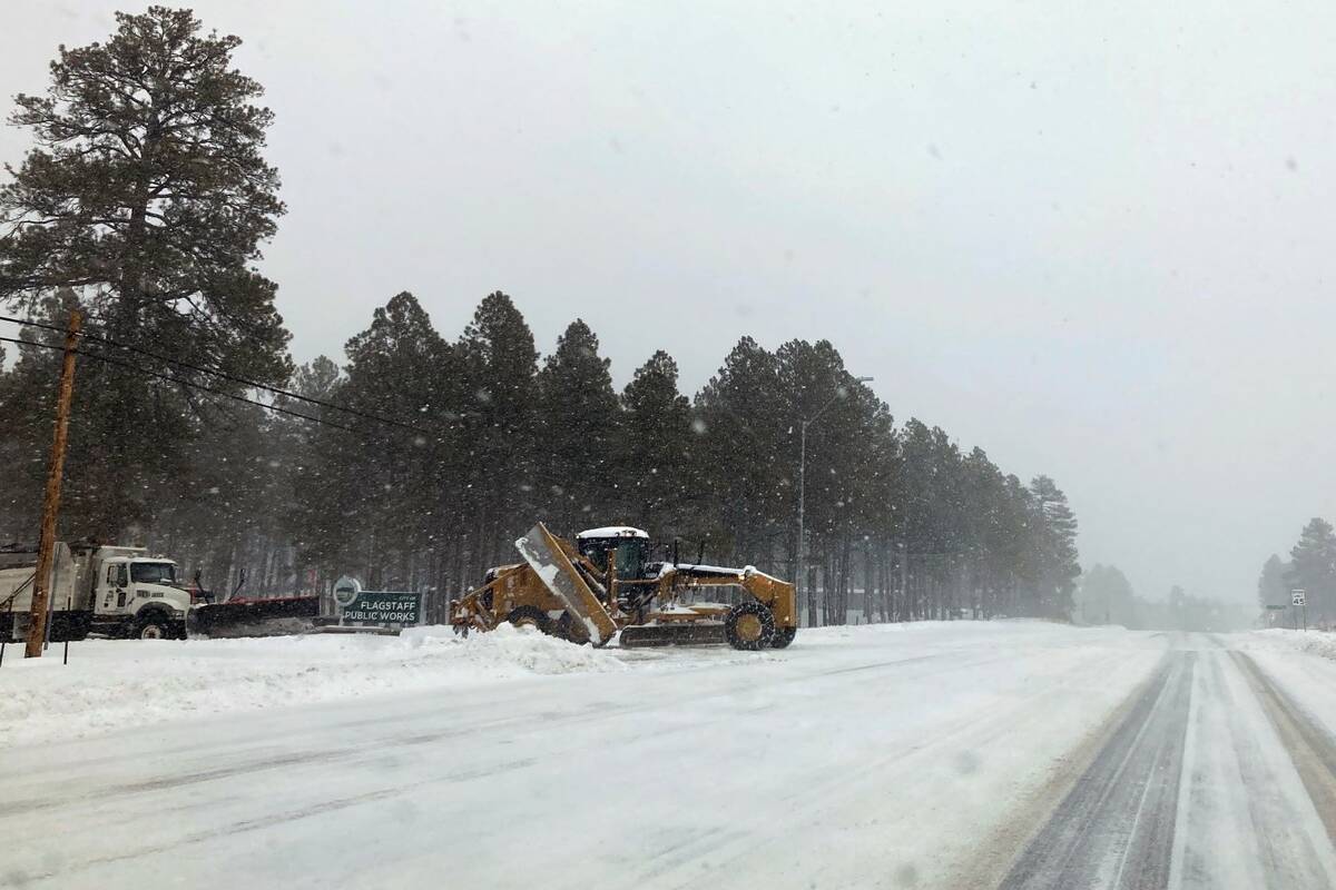 Heavy snow fell across Flagstaff, Ariz., on Wednesday, Feb. 23, 2022. (AP Photo/Felicia Fonseca)
