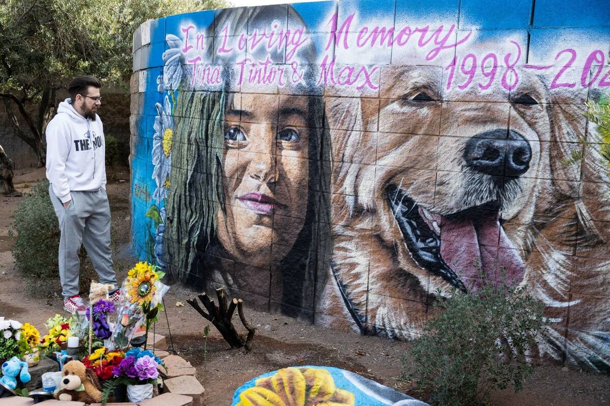 Djordge Tintor visits a mural honoring his sister Tintor and her dog, Max, who were both killed ...