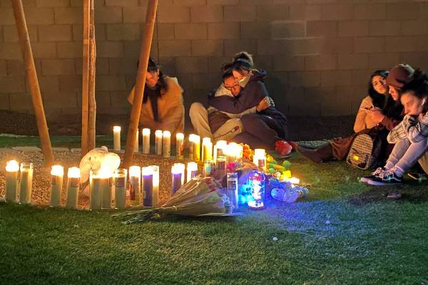 People gather around a memorial for Mason Dominguez, 4, on Wednesday, Feb. 23, 2022, outside th ...