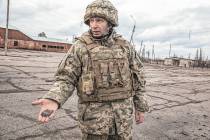 Ukrainian Army general Mykhailo Dropaty displays a shell fragment after shelling by pro-Russian ...