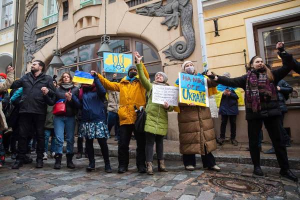 People including Ukrainians, take part in a demonstration in support of Ukraine, outside the Ru ...