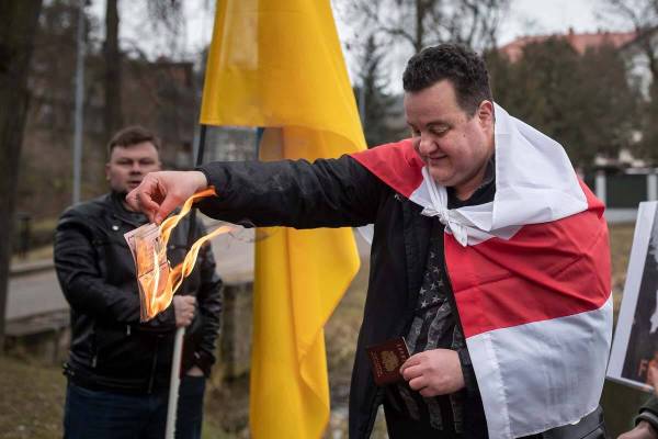 Timote Suladze, a citizen of Belarus and Russia, burns a Russian passport to demonstrates again ...