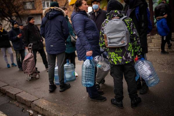 Local residents wait to buy water at a store during a water outage in Kyiv, Ukraine, Thursday, ...