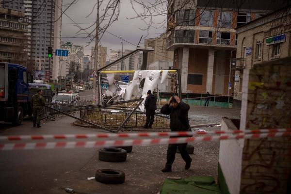 Police officers inspect area after an apparent Russian strike in Kyiv Ukraine, Thursday, Feb. 2 ...