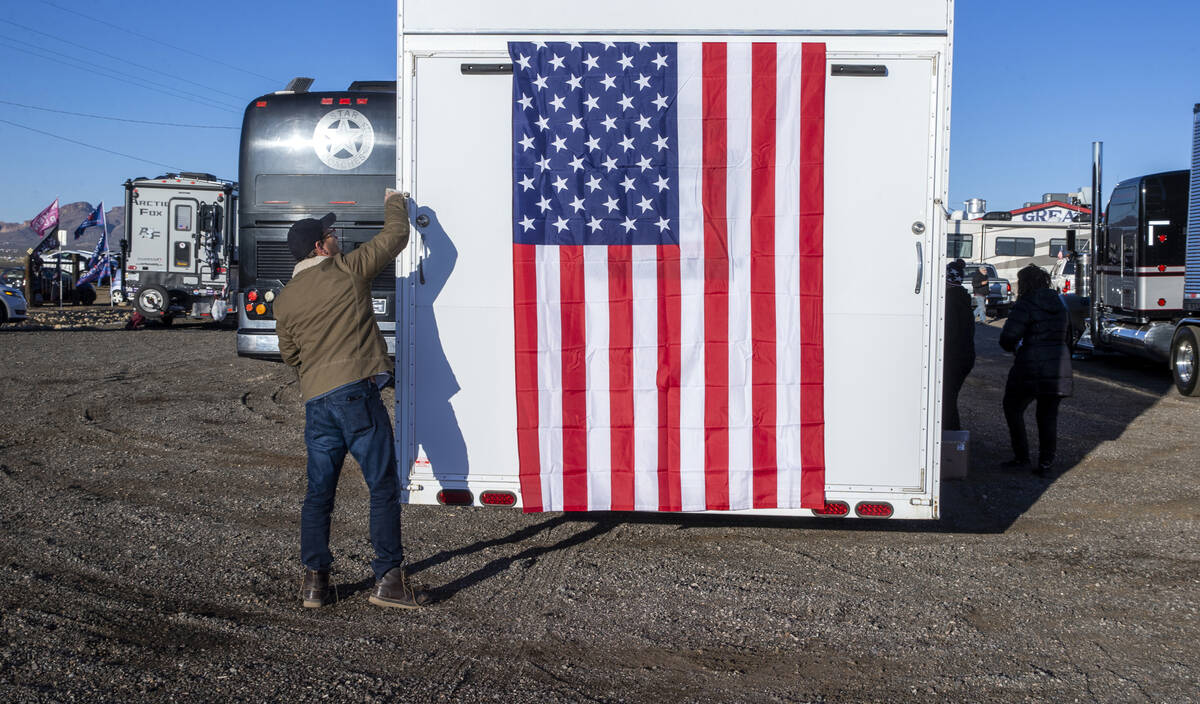 Co-organizer Jeff Hanson of Dallas hangs an American flag from the rear of his trailer as The P ...