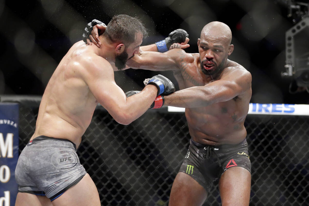 Dominick Reyes, left, and Jon Jones, right, during a light heavyweight mixed martial arts bout ...