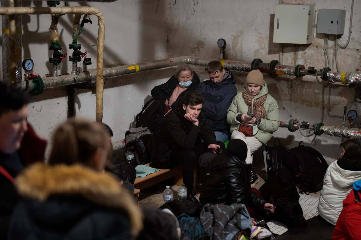People take shelter at a building basement while the sirens sound announcing new attacks in the ...