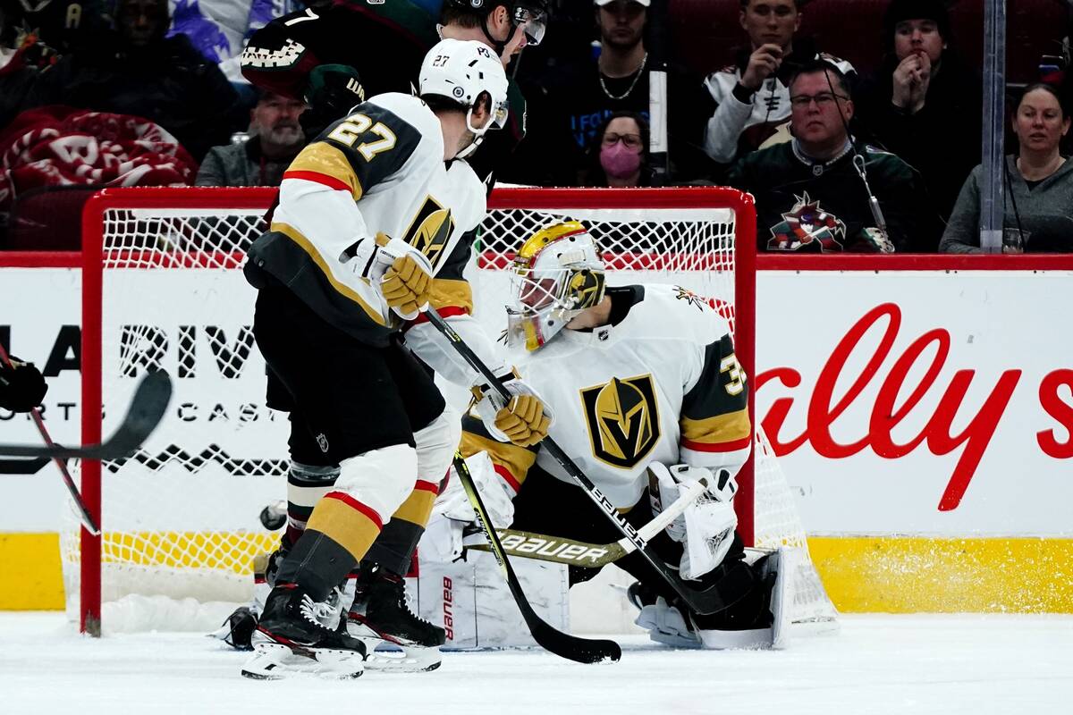 Vegas Golden Knights goaltender Laurent Brossoit, right, gives up a goal to Arizona Coyotes' Sh ...