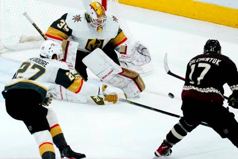 Vegas Golden Knights goaltender Laurent Brossoit (39) makes a save on a shot by Arizona Coyotes ...