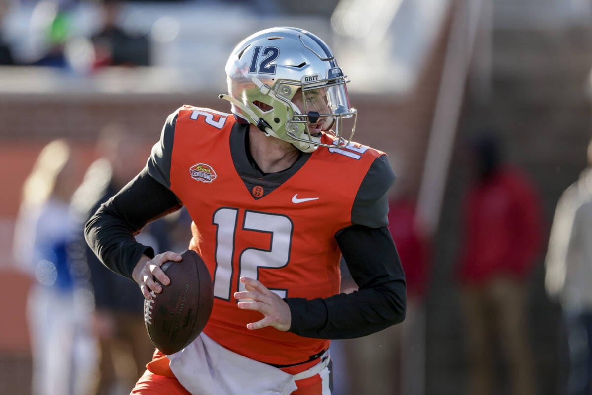 National Team quarterback Carson Strong of Nevada (12) rolls out to pass in an NCAA college foo ...