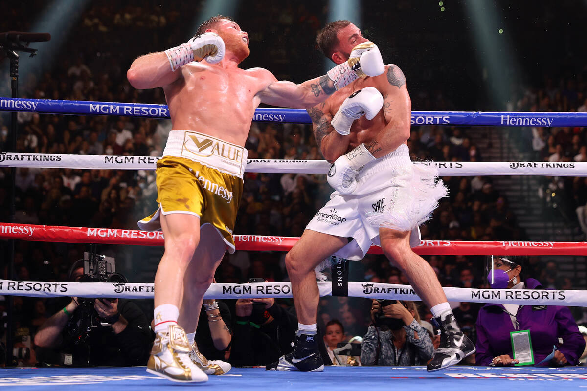 Saul “Canelo” Alvarez, left, connects a punch against Caleb Plant in the seventh ...