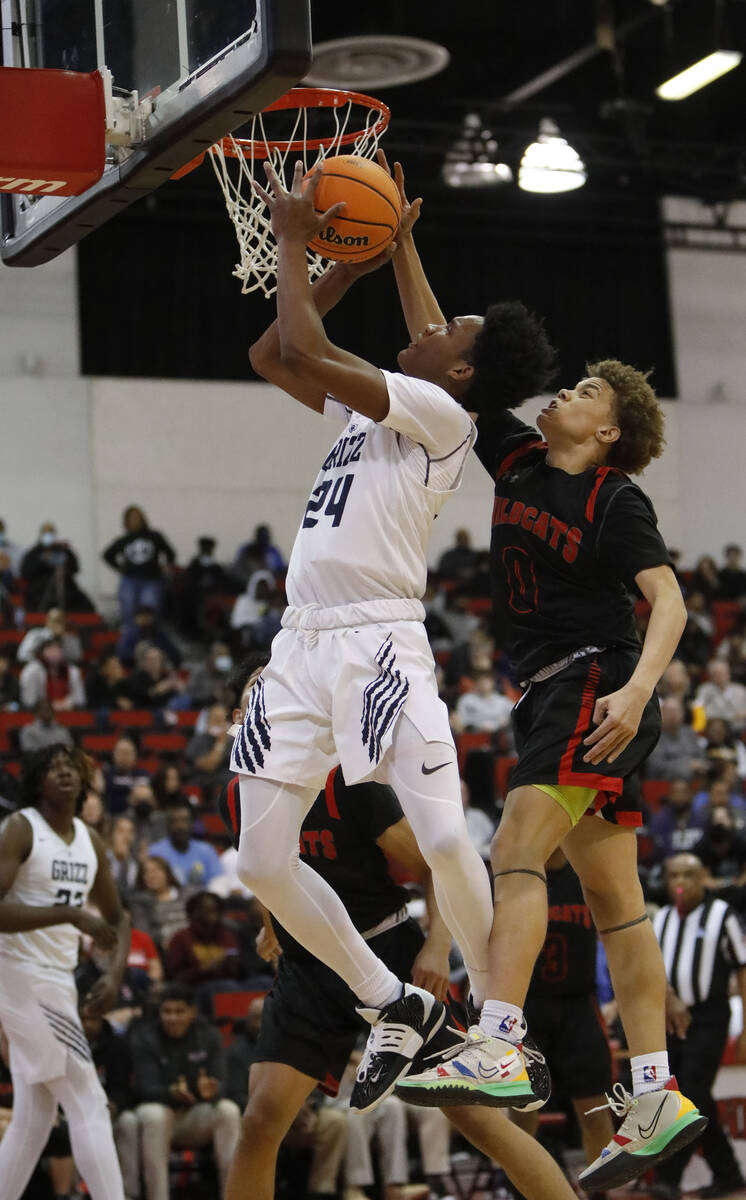 Spring Valley High School's Deasean Moreno (24) jumps to the basket as Las Vegas High School's ...