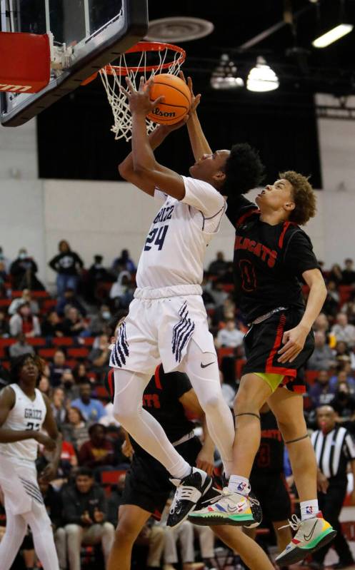 Spring Valley High School's Deasean Moreno (24) jumps to the basket as Las Vegas High School's ...