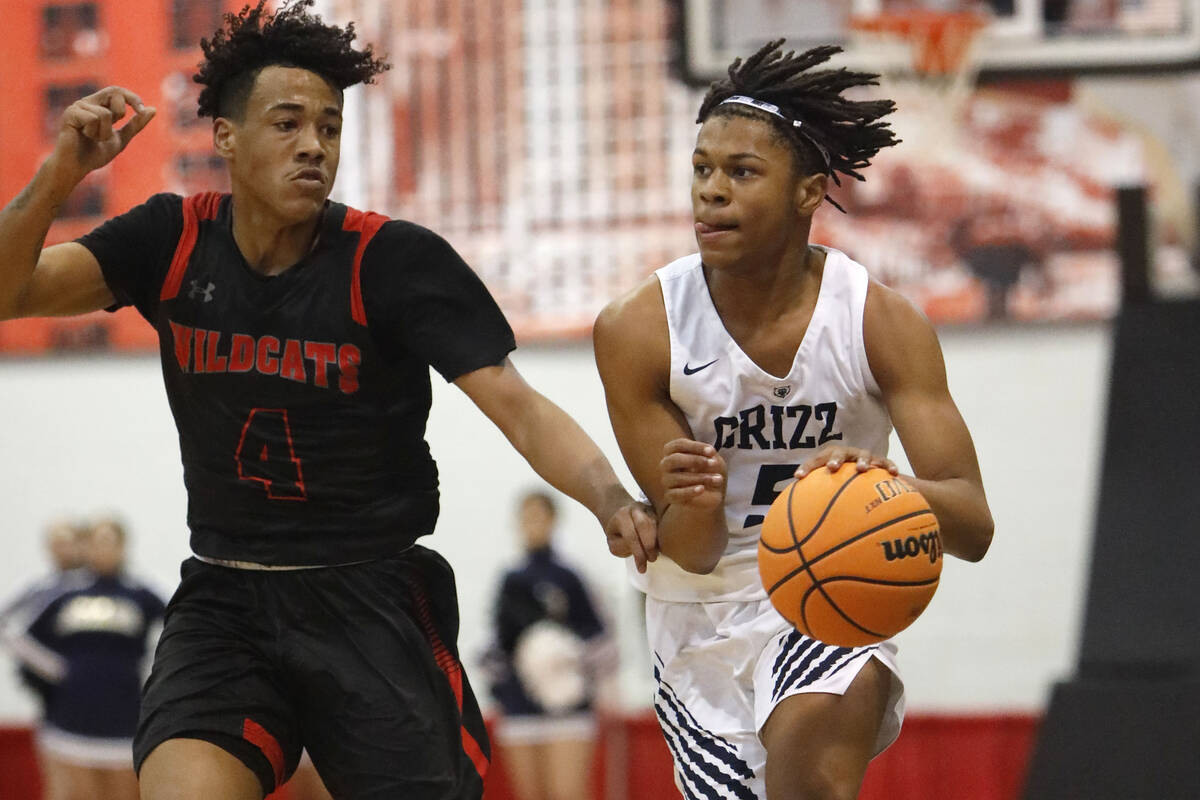 Spring Valley High School's Randy Nance (5) keeps a ball away from Las Vegas High School's Marc ...