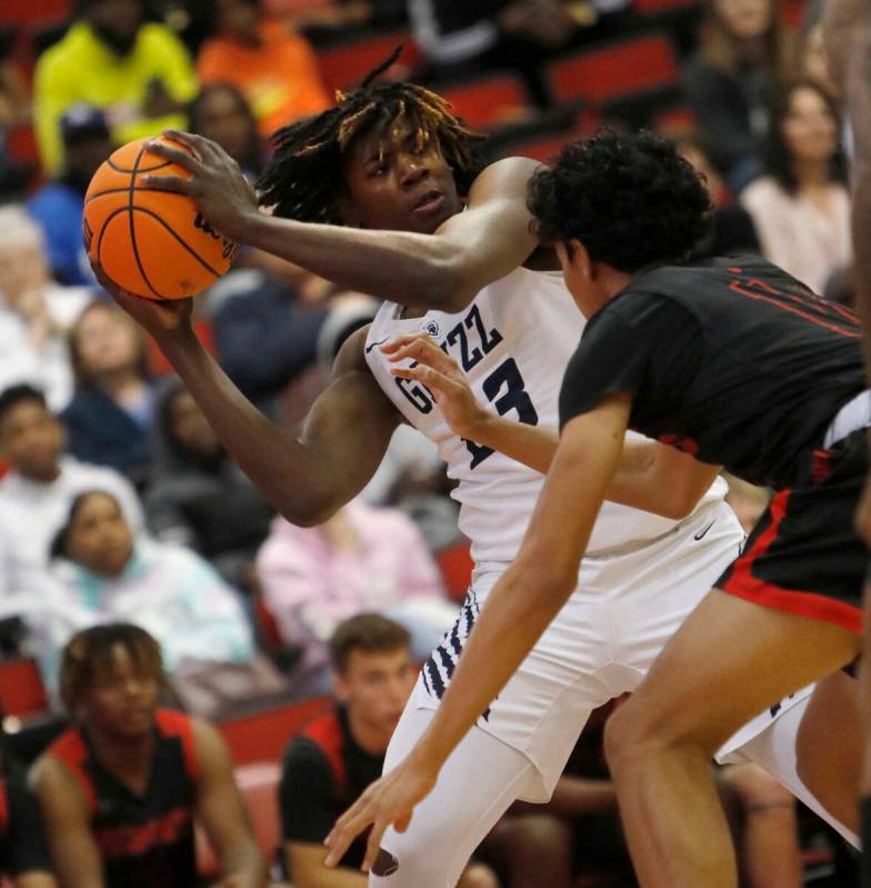 Spring Valley High School's Pharaoh Compton (23) looks to pass against Las Vegas High School's ...