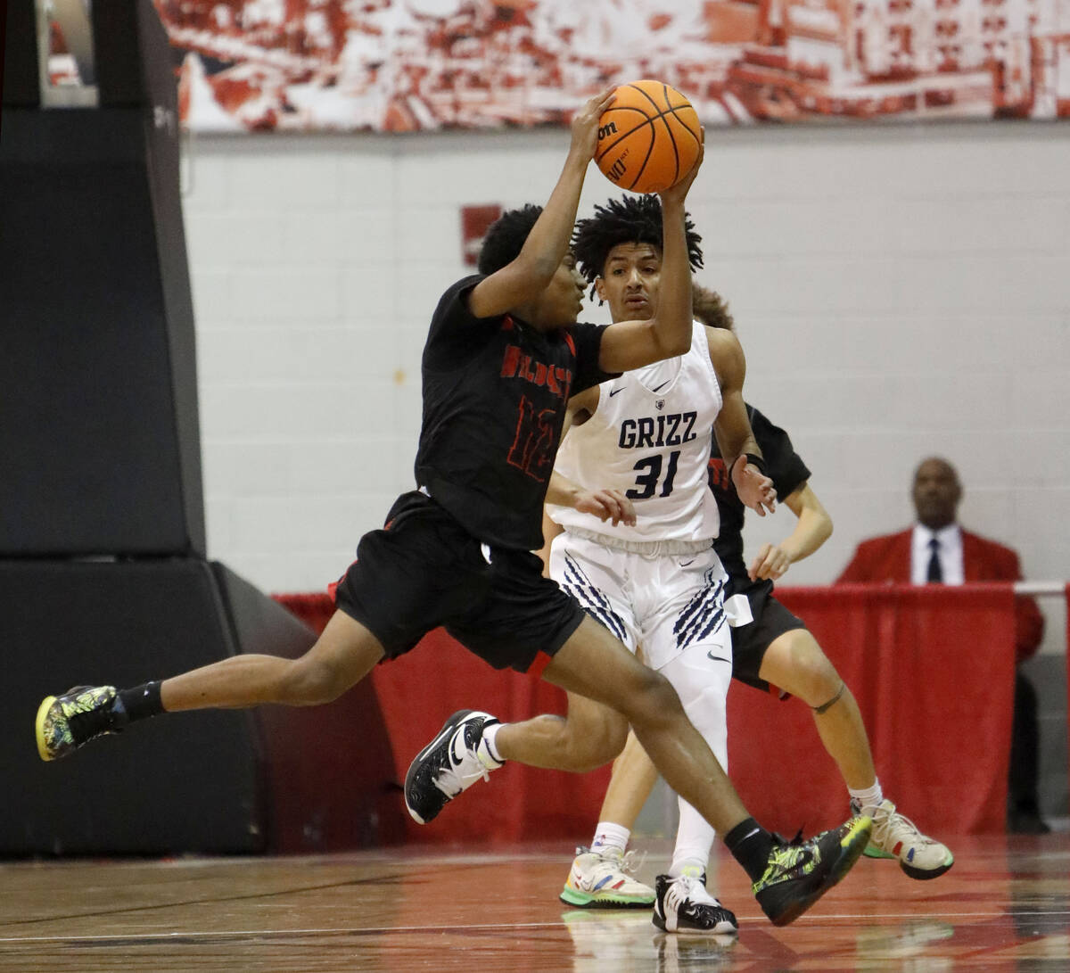 Las Vegas High School's TJ Brown (12) keeps a ball away from Spring Valley High School's Alijah ...