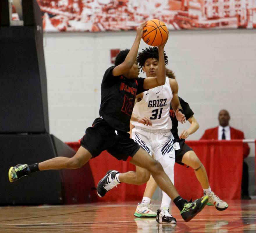 Las Vegas High School's TJ Brown (12) keeps a ball away from Spring Valley High School's Alijah ...