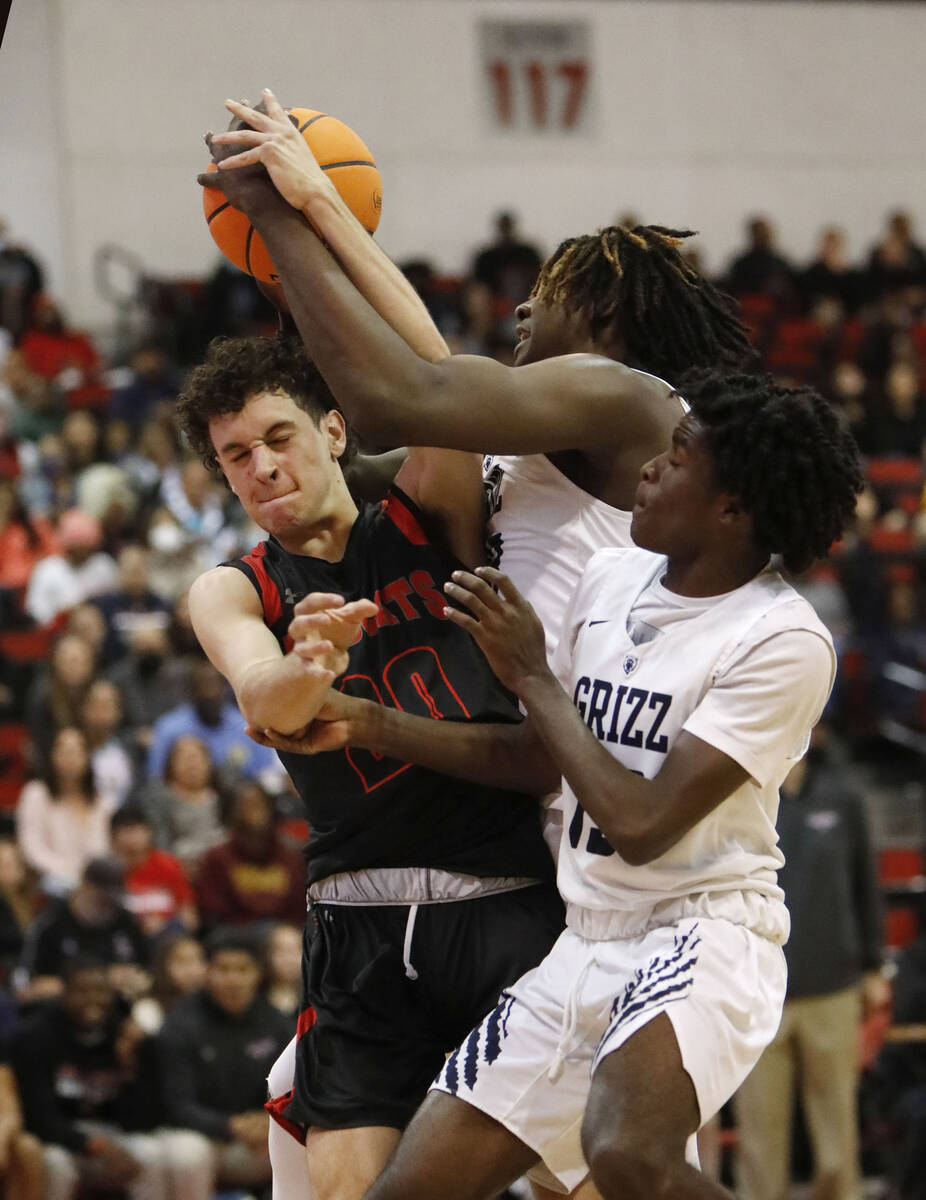 Las Vegas High School's Aidan Wilson (20), Spring Valley High School's Pharaoh Compton (23) and ...