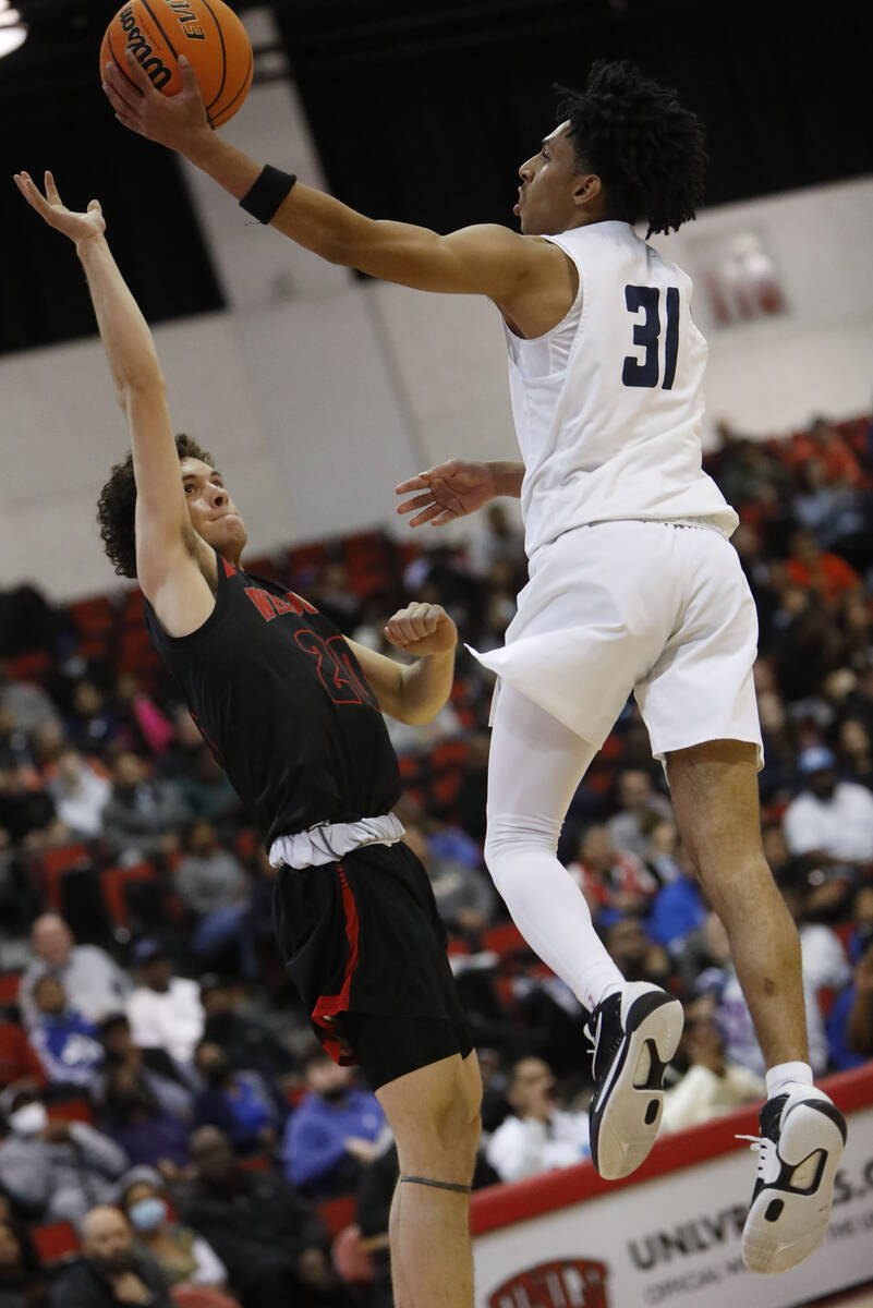 Spring Valley High School's Alijah Adem (31) goes up for a layup against Las Vegas High School' ...