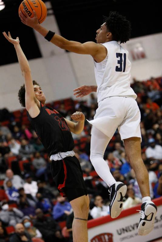 Spring Valley High School's Alijah Adem (31) goes up for a layup against Las Vegas High School' ...