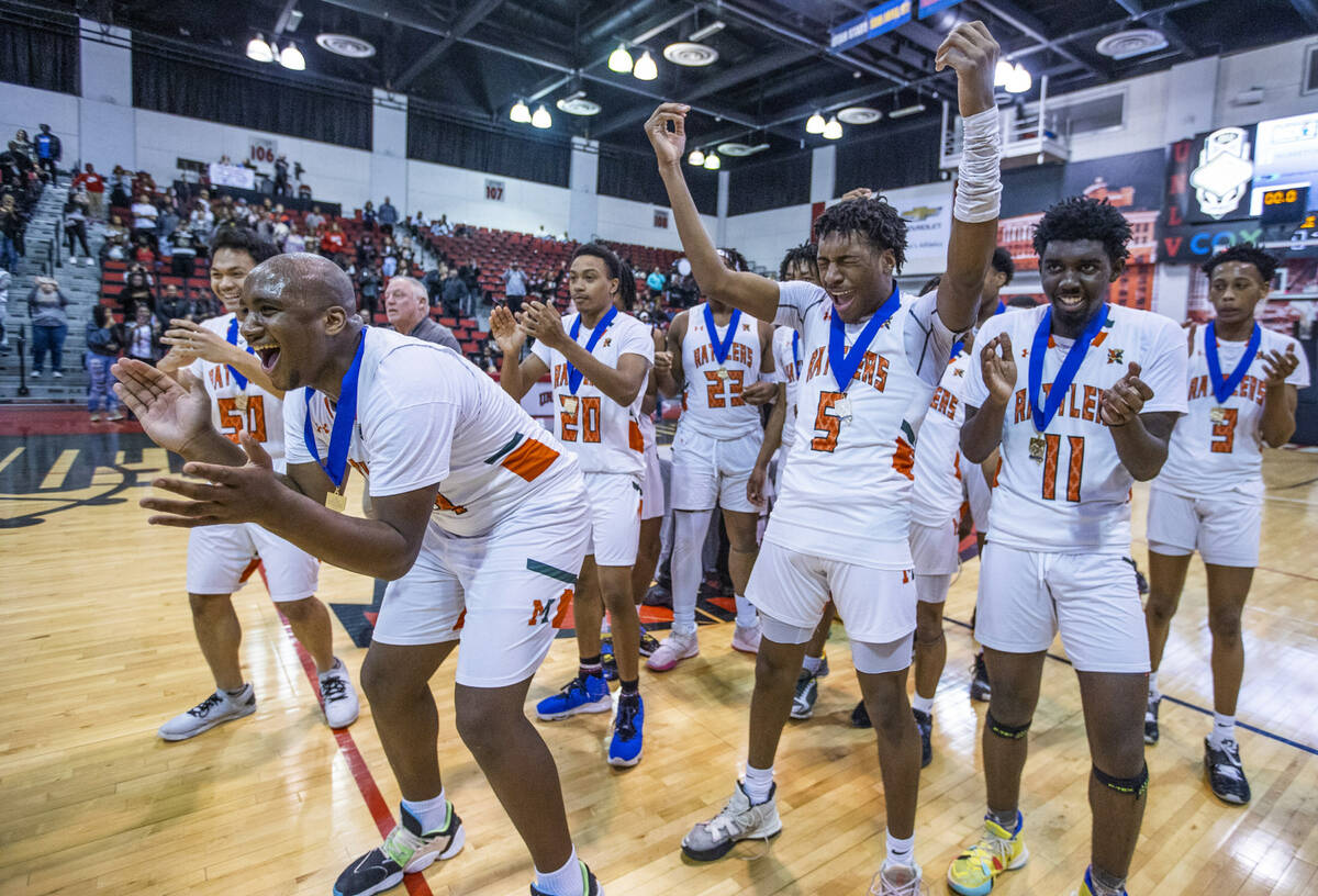 Mojave players celebrate their win over Spring Valley with a final 64-61 following the second h ...