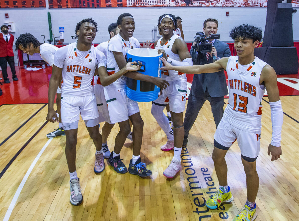 Mojave players pretend to bering over the gatorade as they celebrate their win over Spring Vall ...