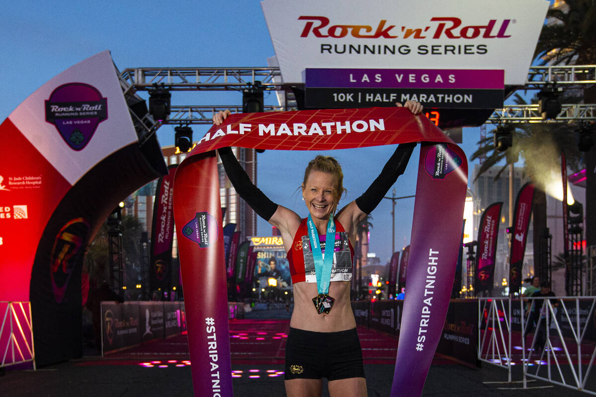 Ellie Stevens, of Las Vegas, poses for photographers after winning the women’s Rock &#x2 ...