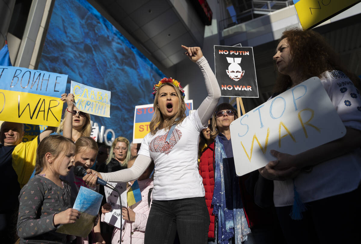 Jenny Arata, middle, from Kyiv, Ukraine, leads demonstrators during a protest over the Russian ...