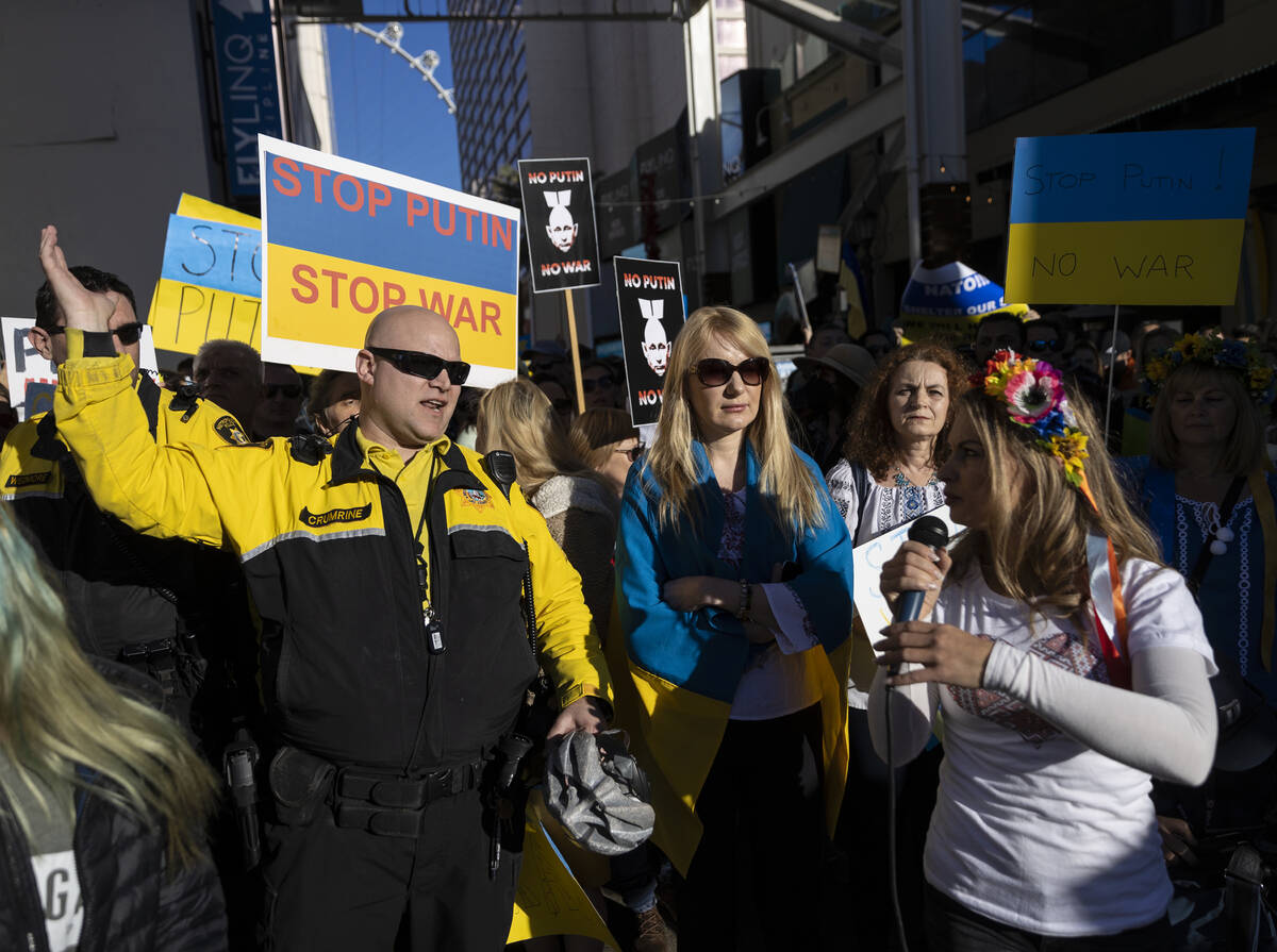 Strip security tries to control a growing group of demonstrators protesting the Russian invasio ...