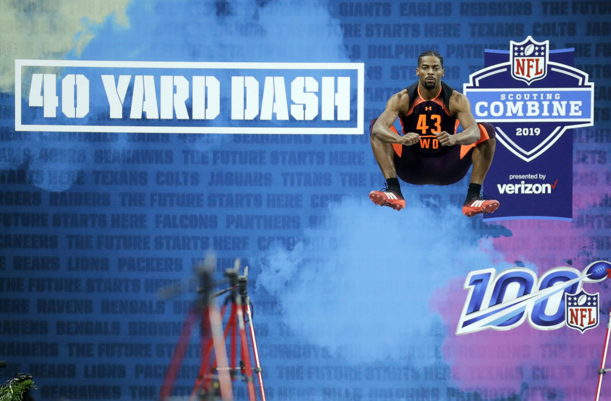 FILE - Auburn wide receiver Darius Slayton jumps before running the 40-yard dash during the NFL ...