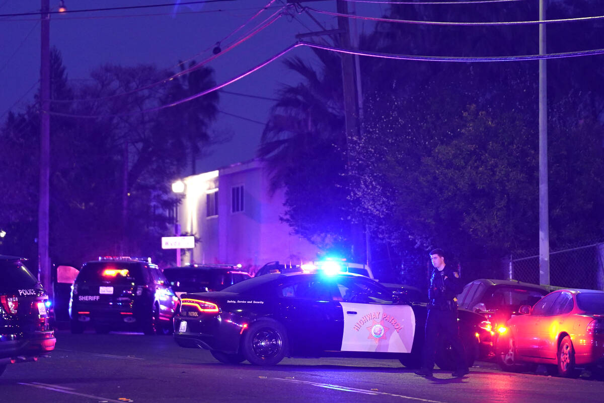 Law enforcement vehicles from several agencies block a street near the scene of a shooting in S ...